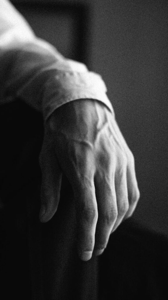 left hand of a man in grayscale photography