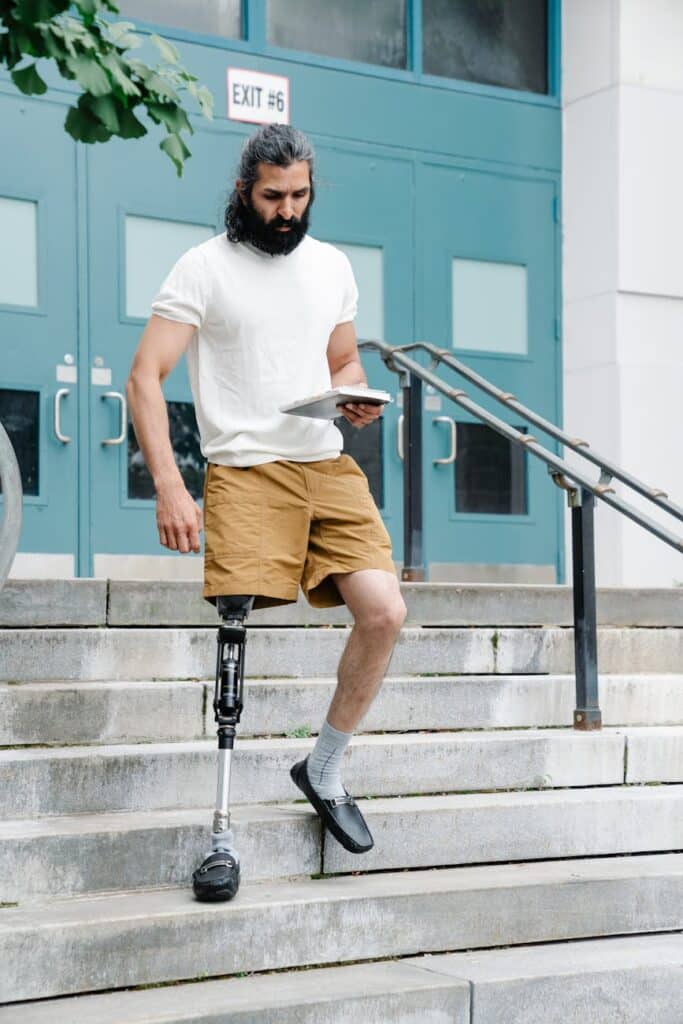 man with prosthetic limb walking down the stairs